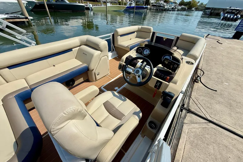 Slide: The Image of 2022 Hurricane FunDeck 2260 REF boat interior with beige seating and steering console. - 26