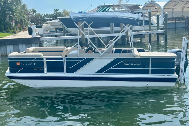 Slide: The Image of 2022 Hurricane FunDeck 2260 REF pontoon boat docked in a marina. - 4