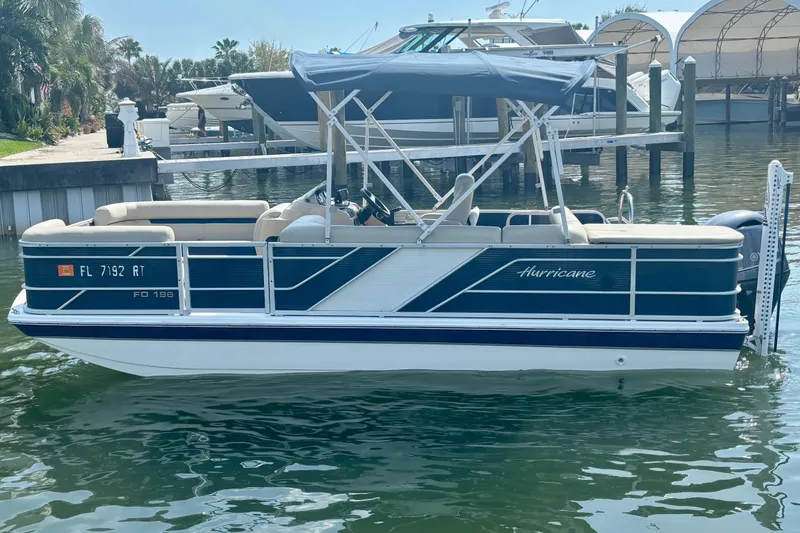 Slide: The Image of 2022 Hurricane FunDeck 2260 REF pontoon boat docked in a marina. - 5