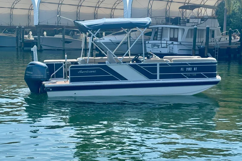 Slide: The Image of 2022 Hurricane FunDeck 2260 REF boat with Yamaha motor docked in marina. - 6