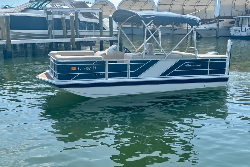 Slide: The Image of 2022 Hurricane FunDeck 2260 REF pontoon boat docked in marina. - 7