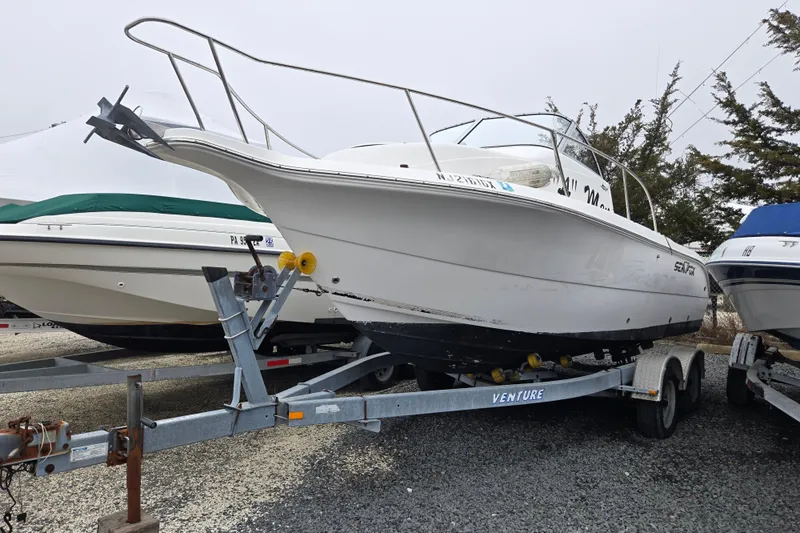 The Image of 2005 Sea Fox 210 Walk Around boat on trailer, parked outdoors. - 0