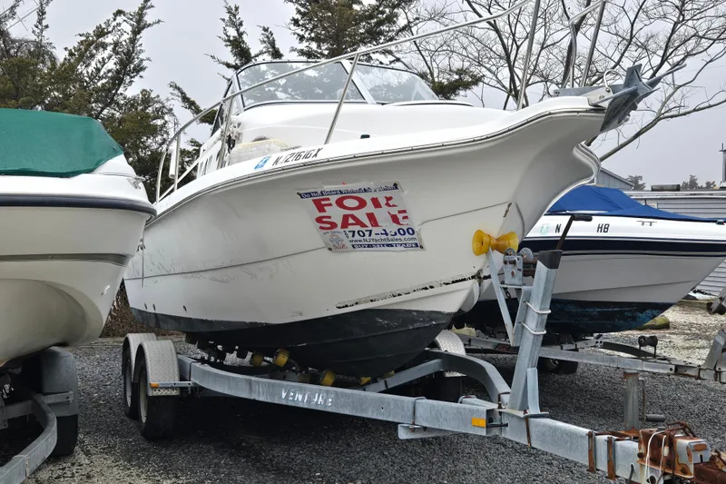 Slide: The Image of 2005 Sea Fox 210 Walk Around boat on trailer, for sale sign displayed. - 4