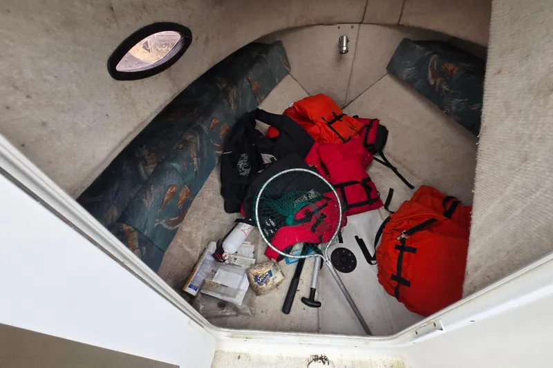 Slide: The Image of Interior of 2005 Sea Fox 210 Walk Around boat with fishing gear and life jackets. - 5