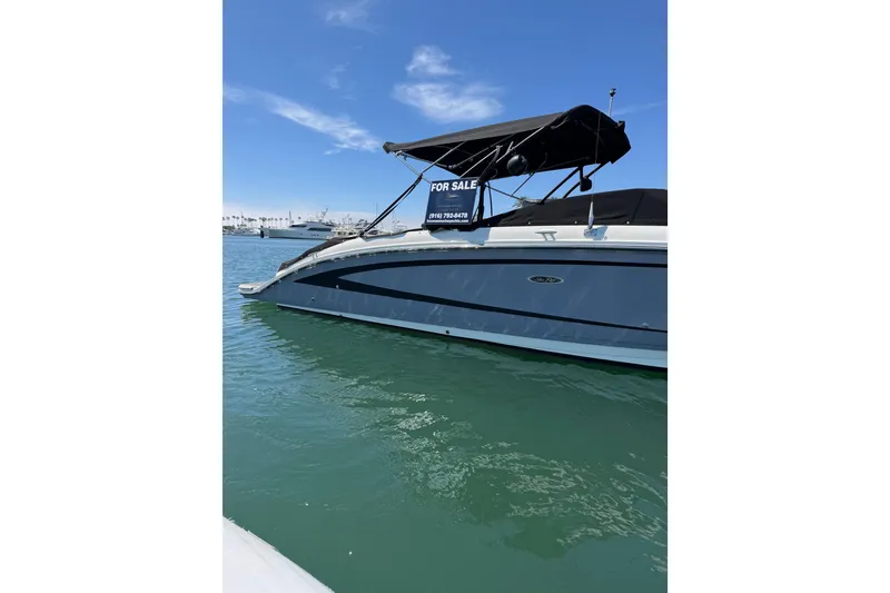 Slide: The Image of 2017 Sea Ray SDX 290 boat for sale on calm water under clear blue sky. - 13