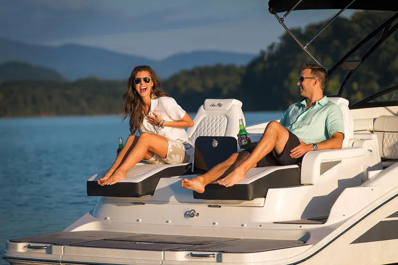 Slide: The Image of Manufacturer Provided Image: Couple relaxing on a 2017 Sea Ray SDX 290 boat in a scenic lake. - 25