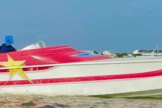 Slide: The Image of Man on 2002 Avanti 42sp speedboat with colorful design on calm water. - 11