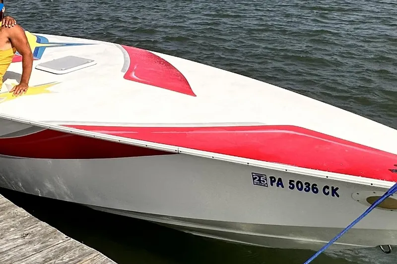 Slide: The Image of 2002 Avanti 42sp speedboat docked, featuring red and white design, registration PA 5036 CK. - 13