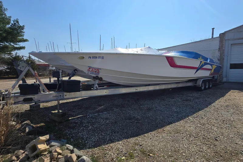 Slide: The Image of 2002 Avanti 41 boat on trailer, for sale, with colorful star design. - 18