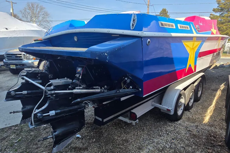 Slide: The Image of 2002 Avanti 41 boat with vibrant star design on trailer. - 19