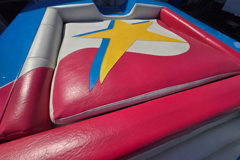 Slide: The Image of Colorful seating area on a 2002 Avanti 41 boat with star design upholstery. - 26