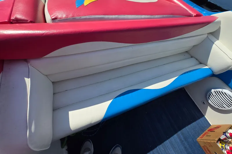 Slide: The Image of Colorful seating on a 2002 Avanti 41 boat, featuring red, white, and blue upholstery. - 27
