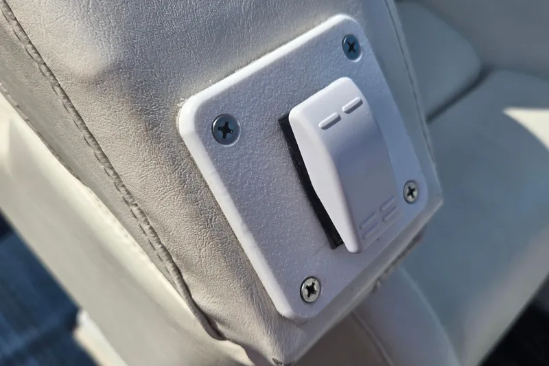 Slide: The Image of Close-up of a white switch on a 2002 Avanti 41 boat seat. - 32