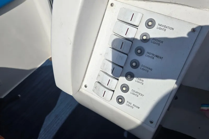 Slide: The Image of Control panel of a 2002 Avanti 41 boat with labeled light switches. - 33