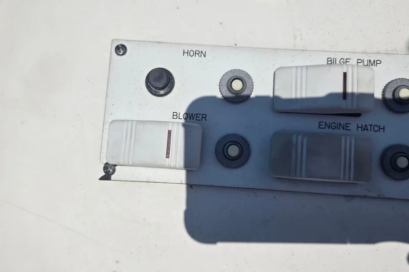 Slide: The Image of Control panel of a 2002 Avanti 41 boat with switches for horn, bilge pump, blower, and engine hatch. - 34