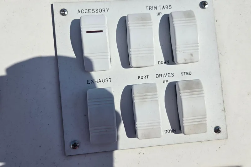 Slide: The Image of Control panel of a 2002 Avanti 41 boat with switches for accessory, trim tabs, and exhaust. - 36