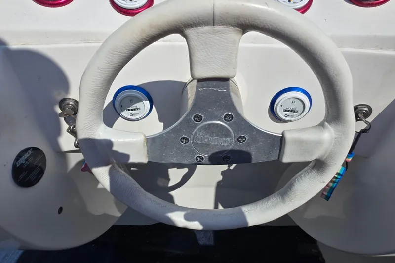Slide: The Image of Steering wheel of a 2002 Avanti 41 boat with gauges and ignition keys. - 38