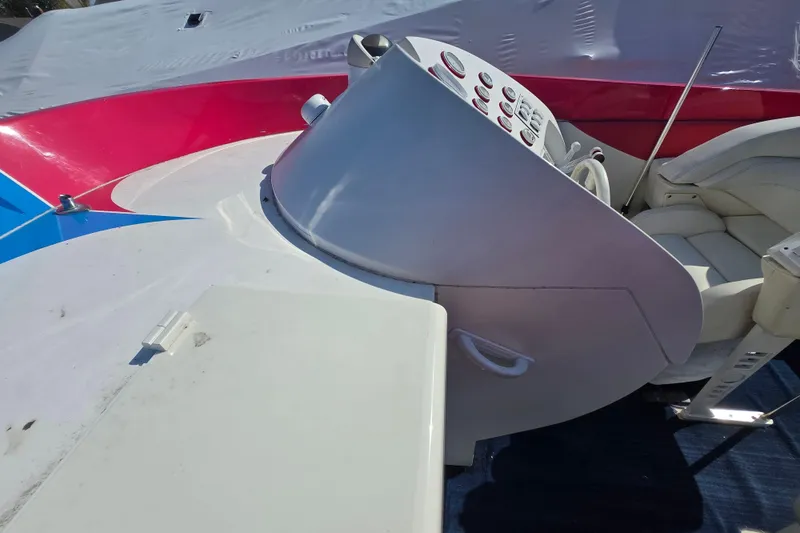 Slide: The Image of Cockpit of a 2002 Avanti 41 boat with colorful dashboard and seating. - 41