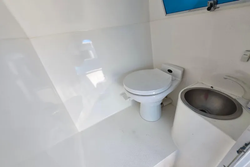 Slide: The Image of Compact bathroom in a 2002 Avanti 41, featuring a toilet and sink. - 42