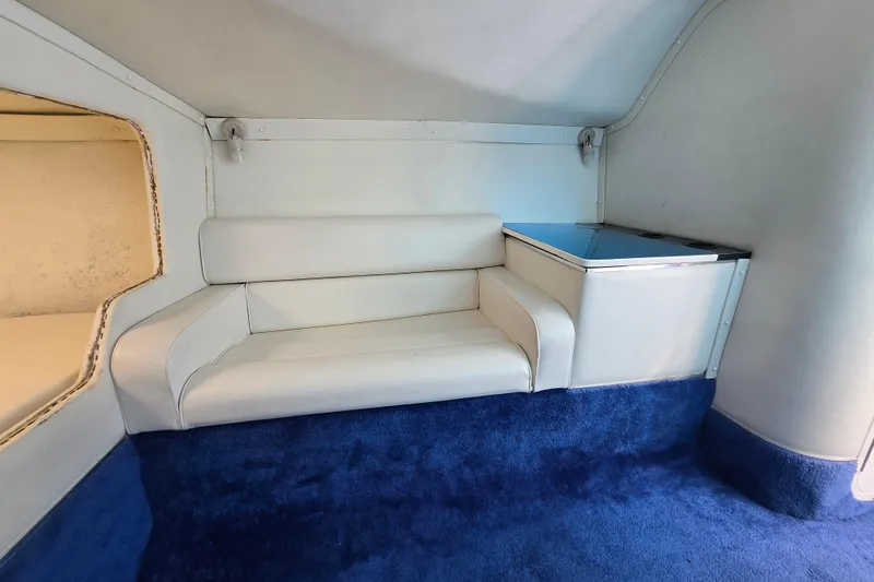 Slide: The Image of Interior of a 2002 Avanti 41, featuring white seating and blue carpet. - 44