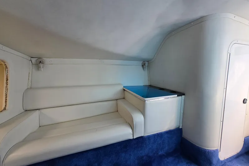 Slide: The Image of Interior of a 2002 Avanti 41 boat with white seating and blue carpet. - 45
