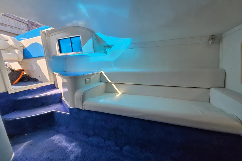 Slide: The Image of Interior of a 2002 Avanti 41 boat with blue carpet and white seating. - 47
