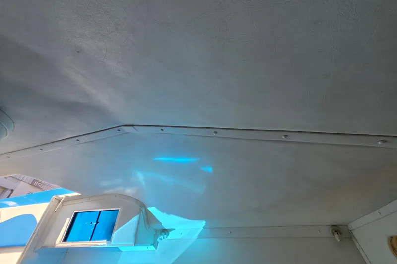 Slide: The Image of Interior ceiling of a 2002 Avanti 41 boat with blue light reflections. - 49