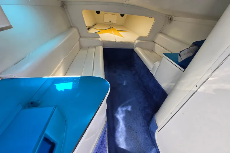 Slide: The Image of Interior of a 2002 Avanti 41 boat with white seating and blue accents. - 50