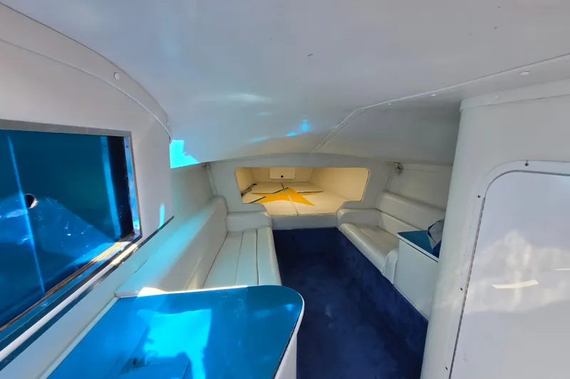 Slide: The Image of Interior of a 2002 Avanti 41 boat, featuring white seating and blue accents. - 51