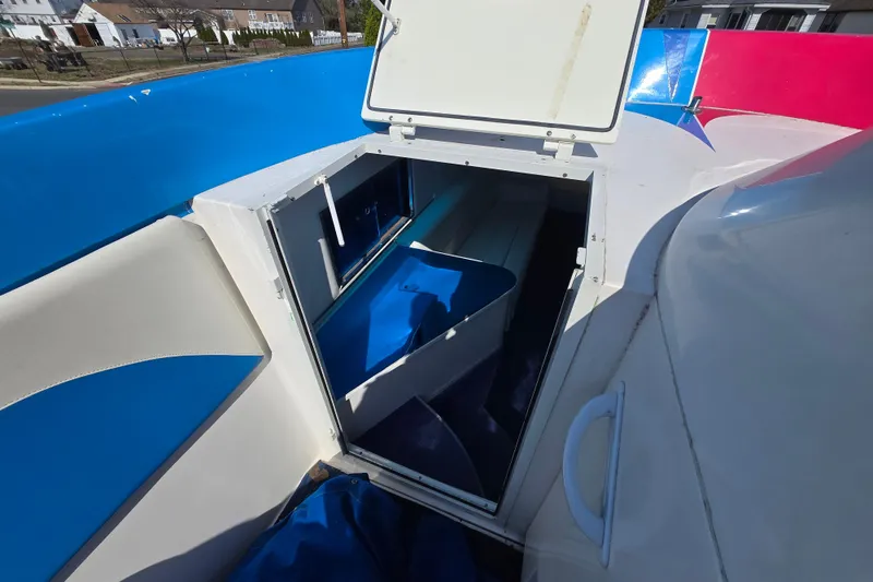 Slide: The Image of 2002 Avanti 41 boat interior with open hatch, showcasing blue and white seating. - 54