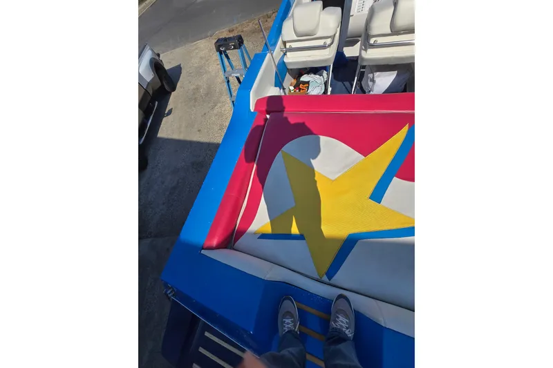 Slide: The Image of 2002 Avanti 41 boat with colorful star design on deck, viewed from above. - 56