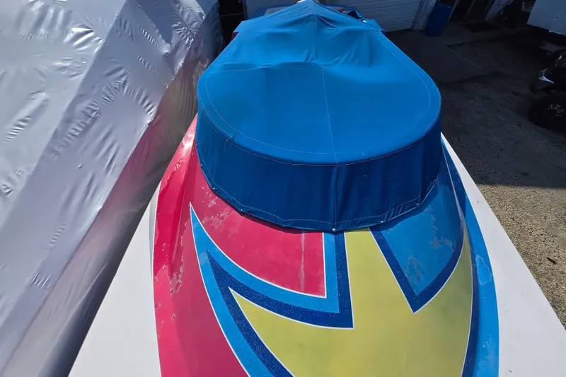 Slide: The Image of Colorful 2002 Avanti 41 boat with blue cover and vibrant design. - 58