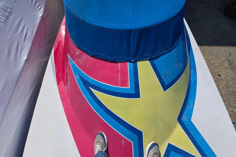 Slide: The Image of Colorful deck of a 2002 Avanti 41 boat with star design and blue cover. - 59