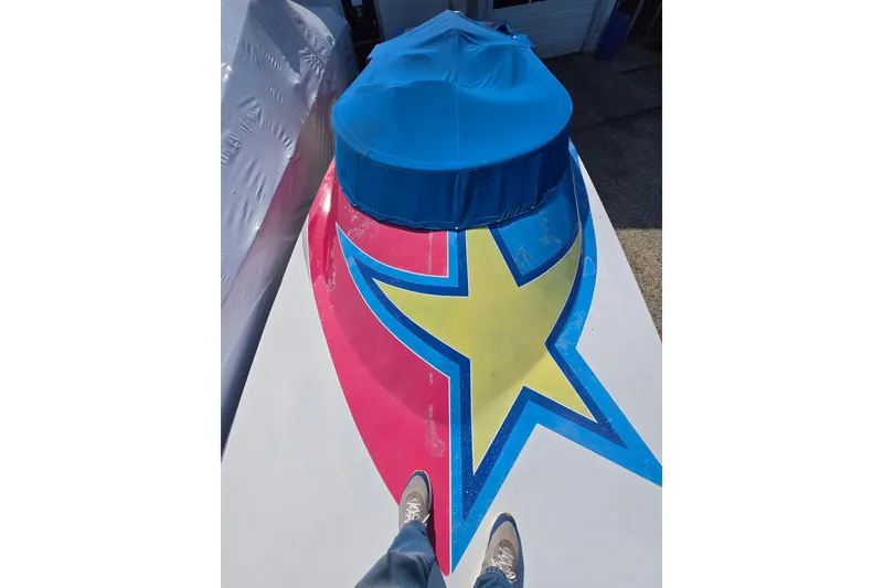 Slide: The Image of 2002 Avanti 41 boat with vibrant star design and blue cover. - 61