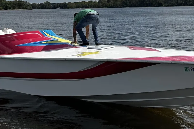 Slide: The Image of Group enjoying a ride on a 2002 Avanti 42sp boat with patriotic design. - 7