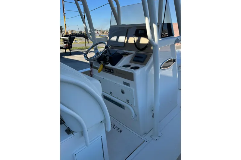 Slide: The Image of 2016 ShearWater 27 Carolina boat console with steering wheel and controls. - 3