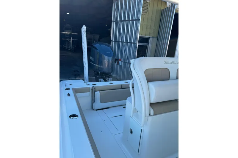 Slide: The Image of 2016 ShearWater 27 Carolina boat interior with Yamaha engine in a storage facility. - 6