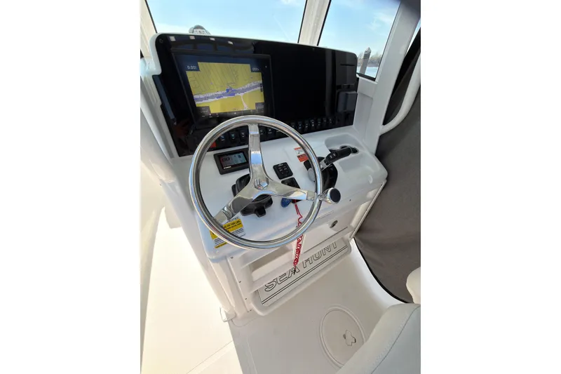 Slide: The Image of 2020 Sea Hunt Ultra 255 SE helm with steering wheel and navigation display. - 10