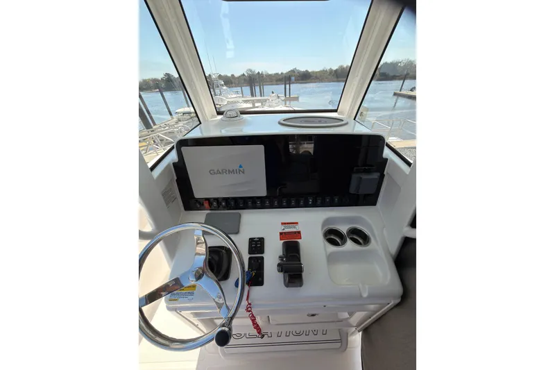 Slide: The Image of 2020 Sea Hunt Ultra 255 SE helm with Garmin display and steering wheel. - 11