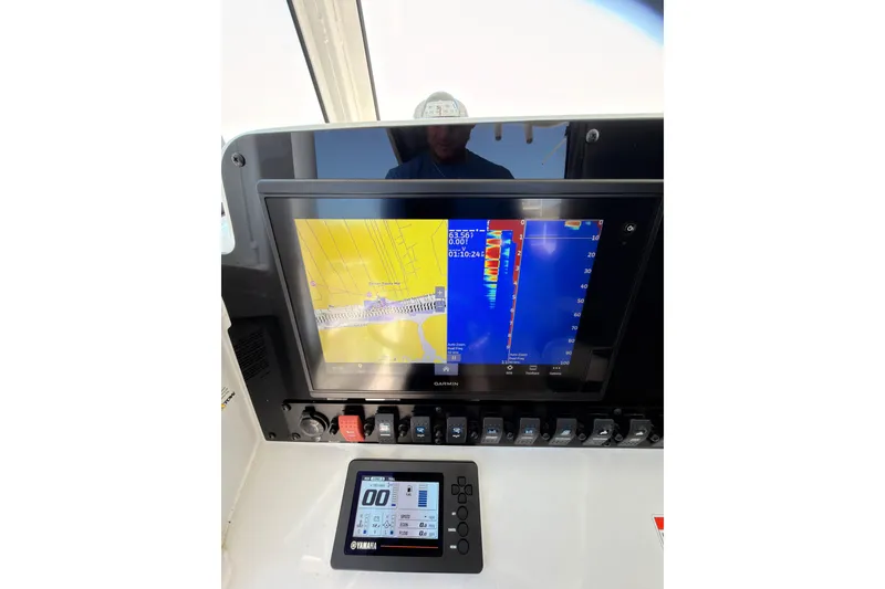 Slide: The Image of 2020 Sea Hunt Ultra 255 SE dashboard with Garmin navigation display and Yamaha controls. - 12