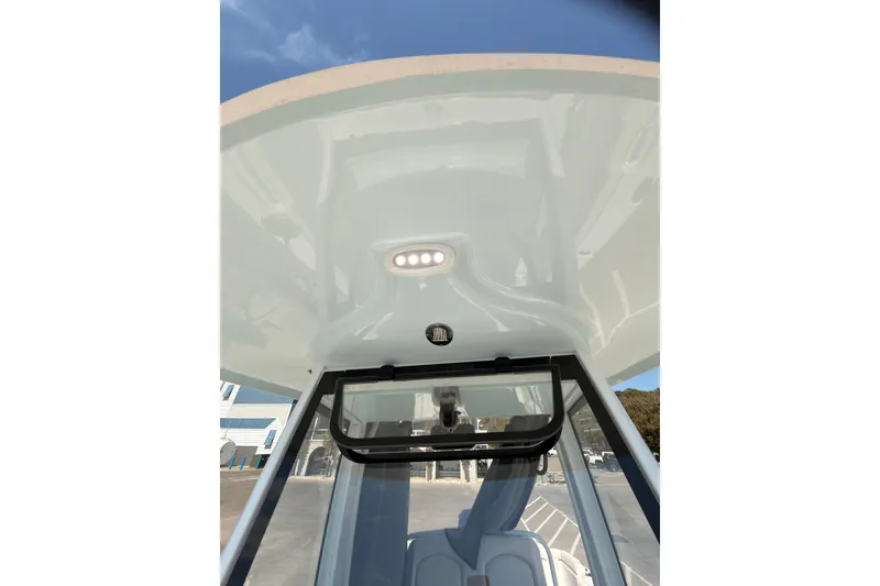 Slide: The Image of 2020 Sea Hunt Ultra 255 SE boat interior with overhead lighting and seating. - 13