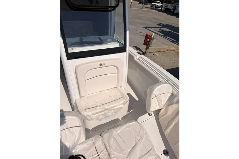 Slide: The Image of 2020 Sea Hunt Ultra 255 SE boat interior with covered seating and console. - 15