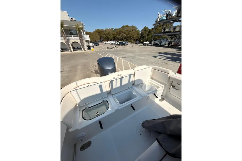 Slide: The Image of 2020 Sea Hunt Ultra 255 SE boat interior at marina, showcasing storage compartments. - 17