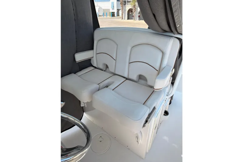 Slide: The Image of 2020 Sea Hunt Ultra 255 SE boat seating, featuring white cushioned seats and armrests. - 20