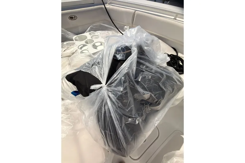 Slide: The Image of Plastic-wrapped items on a 2020 Sea Hunt Ultra 255 SE boat interior. - 23