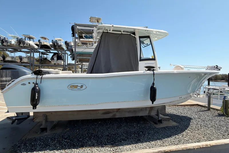 Slide: The Image of 2020 Sea Hunt Ultra 255 SE boat on display at a marina. - 3