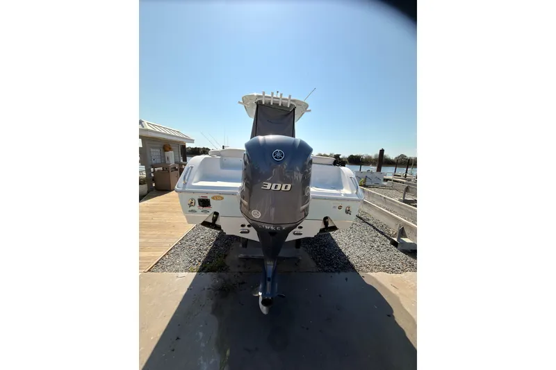 Slide: The Image of 2020 Sea Hunt Ultra 255 SE boat with powerful 300 horsepower engine docked. - 4