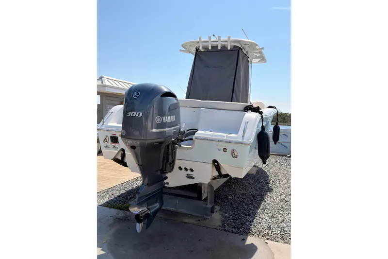Slide: The Image of 2020 Sea Hunt Ultra 255 SE boat with Yamaha 300 engine, docked outdoors. - 5