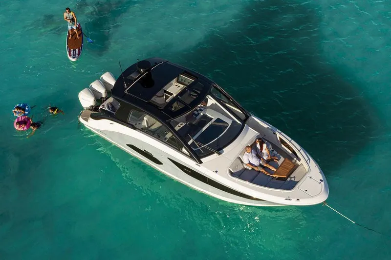Slide: The Image of Manufacturer Provided Image: 2022 Sea Ray Sundancer 370 OB yacht on turquoise water with people swimming nearby. - 6