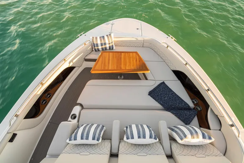Slide: The Image of Manufacturer Provided Image: 2022 Sea Ray Sundancer 370 OB boat with luxurious seating and table on calm water. - 7
